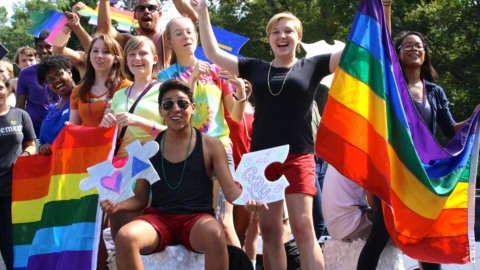 Students celebrate in the NC Pride parade from atop the UNC float.